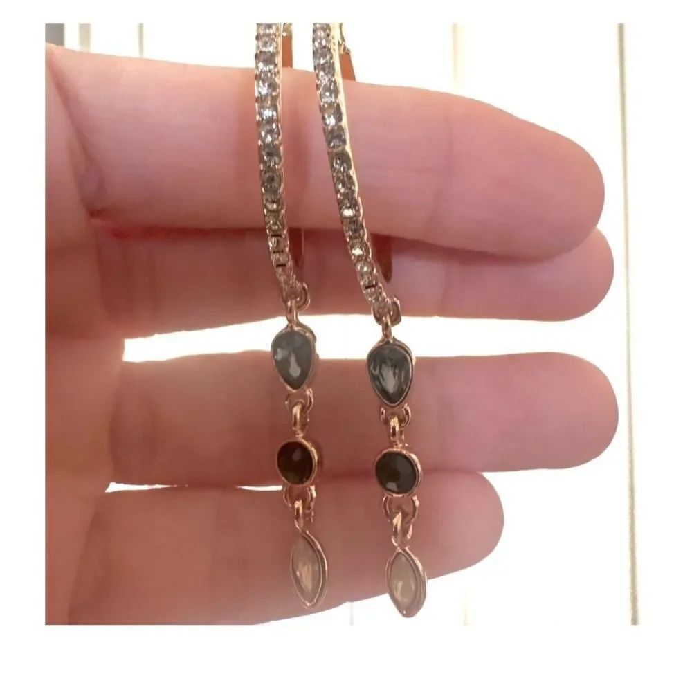 Gold tone hoop earrings with dangling rhinestones